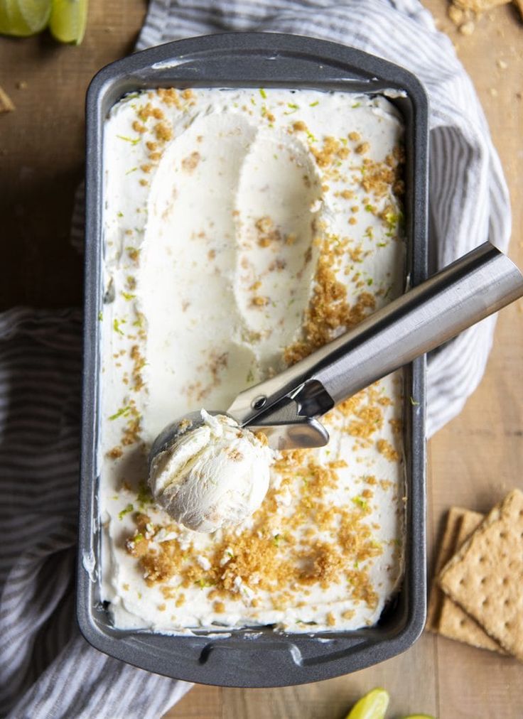 an ice cream sundae with graham crackers and limes on the side in a pan