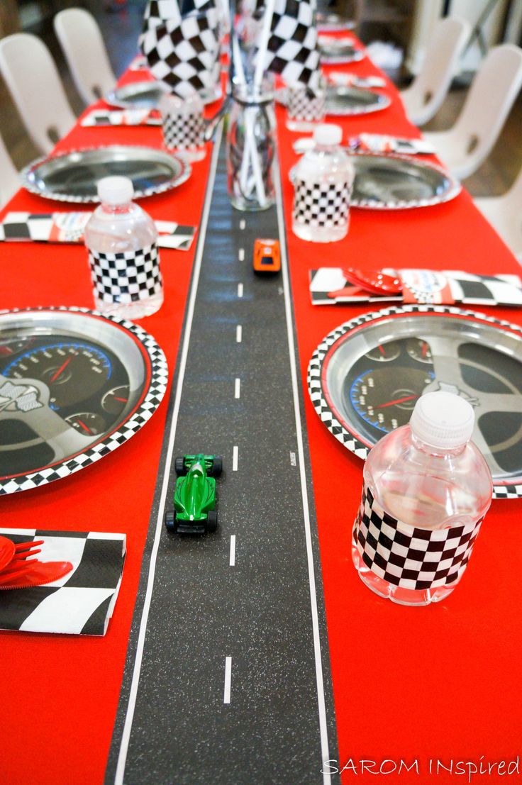 a long table set with racing themed plates and place settings for race cars on it