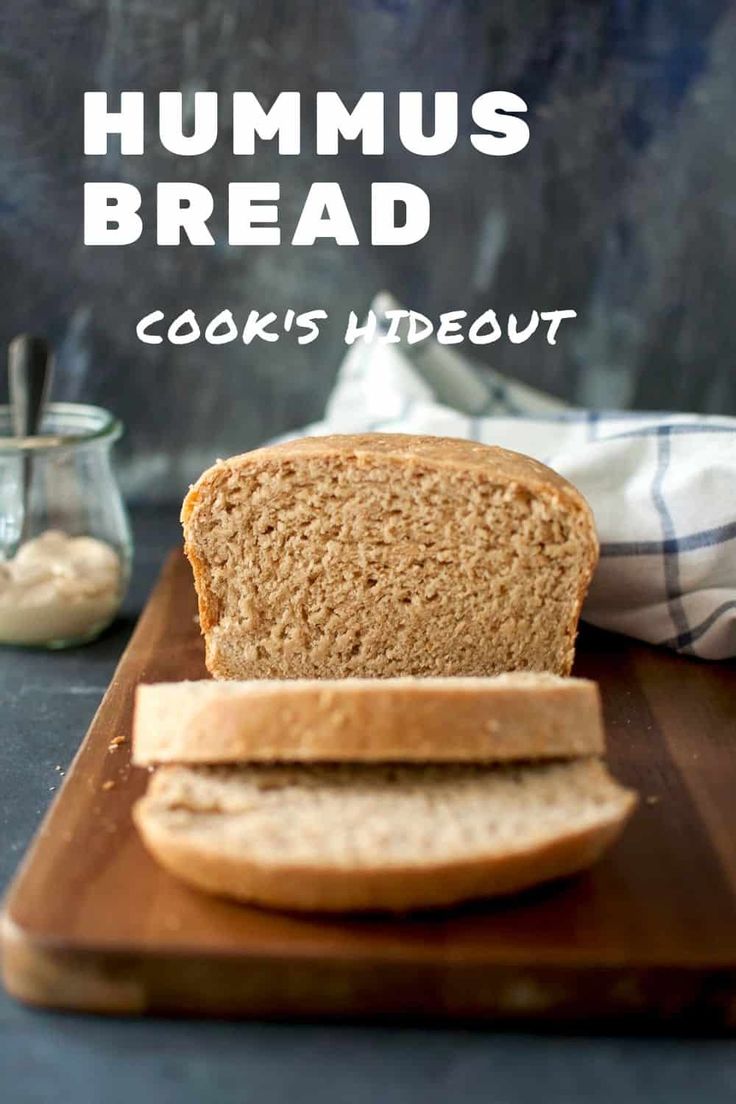 a loaf of bread sitting on top of a wooden cutting board