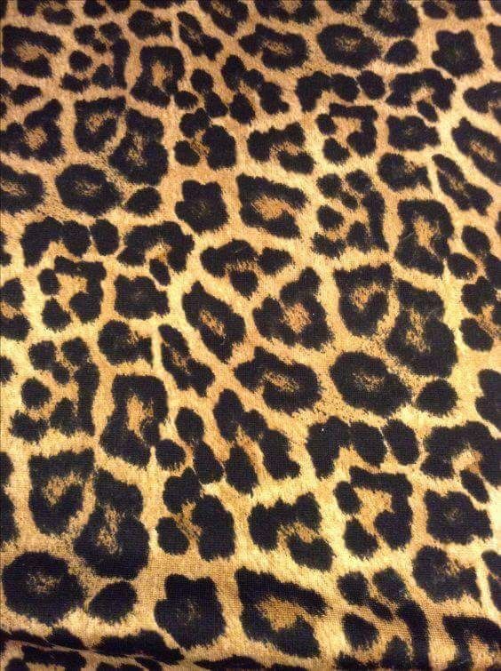 an animal print fabric with black and brown spots