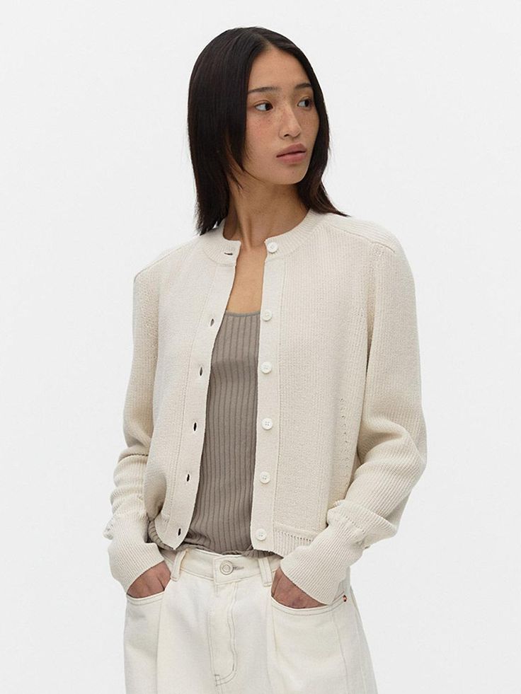 Cardigan in a soft, rib-knit cotton blend with buttons at front and ribbing at neckline, cuffs, and hem.- Long sleeve- Round neck- Button fastening- Toned-down cream and light grayish color Cashmere Cardigan With Ribbed Cuffs For Spring, Spring Cashmere Cardigan With Ribbed Cuffs, Ribbed Button-up Outerwear For Work, Ribbed Button-up Outerwear For Office, Knit Button-up Sweater With Ribbed Cuffs, Workwear Button-up Cardigan With Ribbed Collar, Classic Workwear Sweater With Button Cuffs, Ribbed Cardigan For Work, Spring Cashmere Cardigan With Button Cuffs