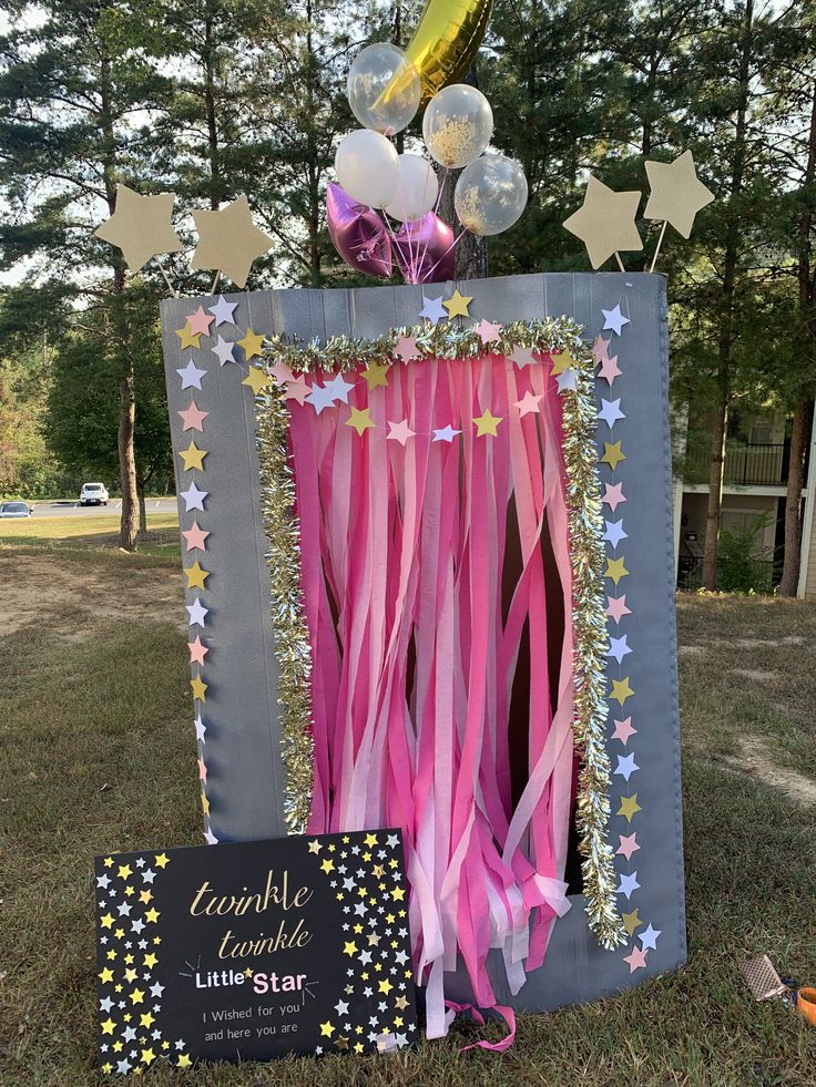 a little star themed birthday party with balloons and streamers in the shape of a photo frame