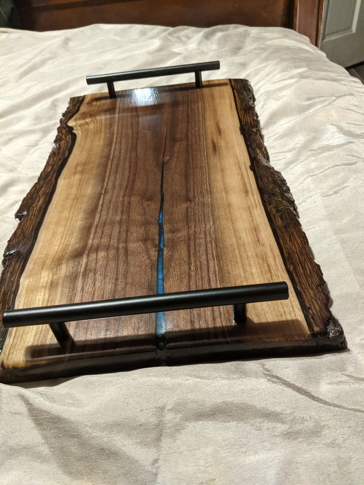 a wooden tray sitting on top of a bed