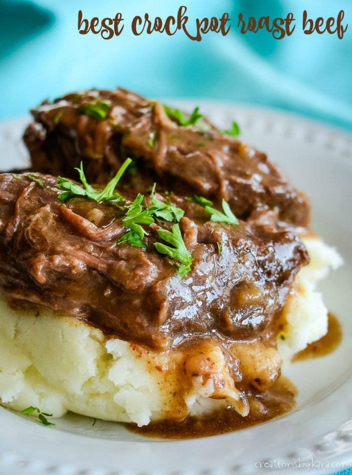 a white plate topped with mashed potatoes covered in gravy