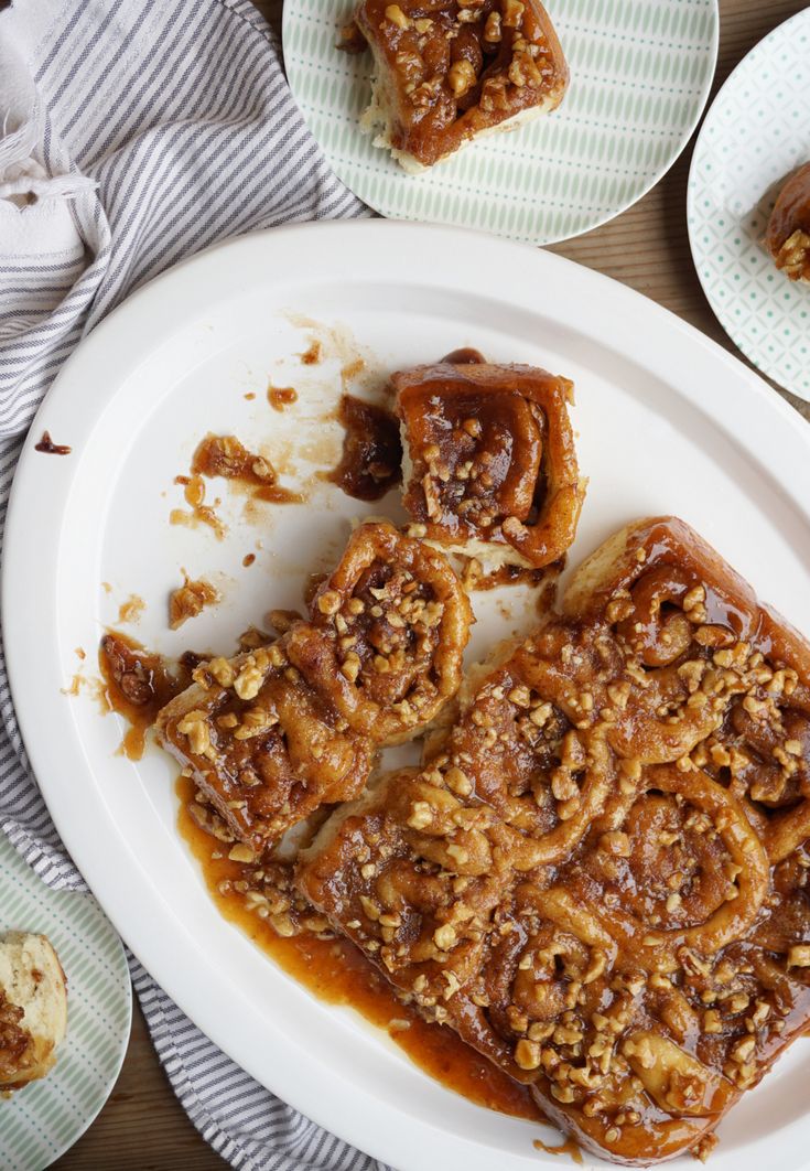 some food is sitting on a white plate and next to other plates with desserts