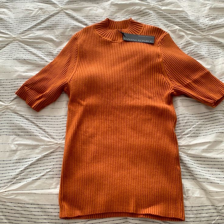 Burnt Orange Sweater Top. New With Tags. Size L Trendy Winter Tops With Short Sleeves, Fall Short Sleeve Sweater With Ribbed Neckline, Casual Orange Ribbed Top, Orange Ribbed Crew Neck Top, Orange Knit Tops For Fall, Ribbed Short Sleeve Sweater For Spring, Spring Ribbed Short Sleeve Sweater, Fitted Orange Ribbed Top, Trendy Short Sleeve Fall Sweater