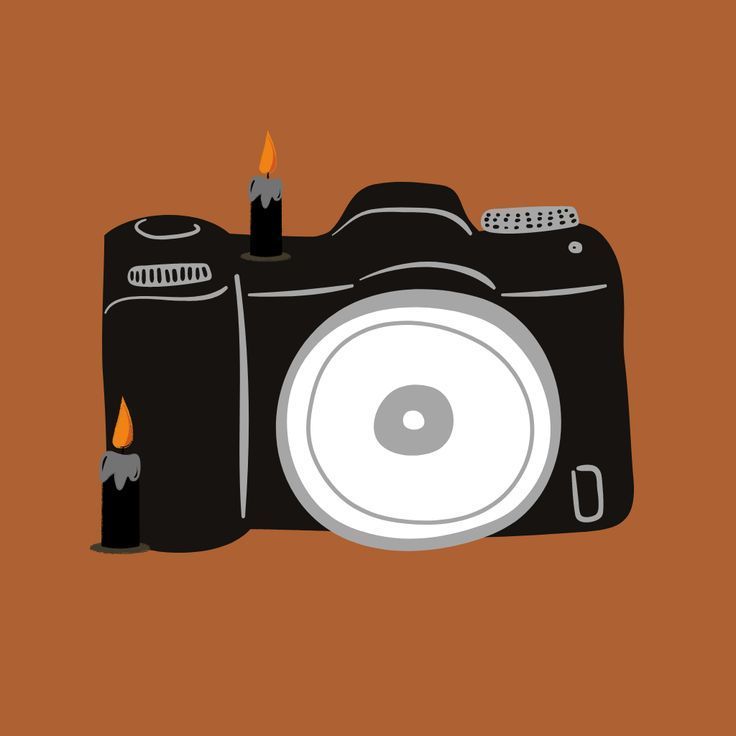 a camera with two candles on the front and one burning in the back, against an orange background