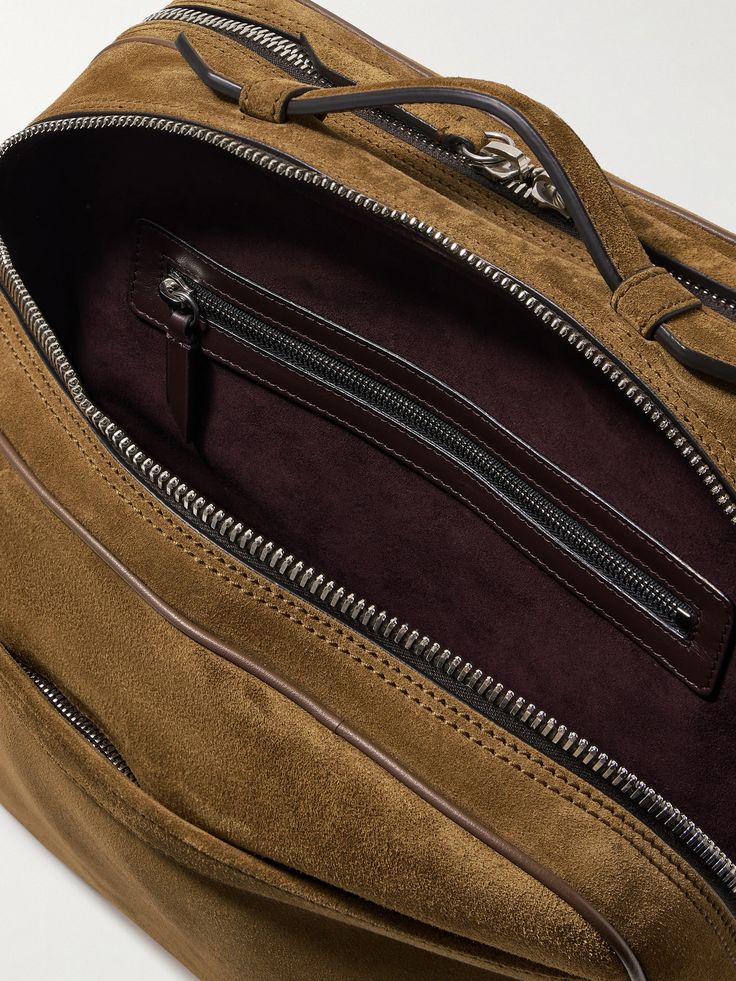 Inspired by vintage flight styles, Métier's 'Wanderer' messenger bag combines the look of a traditional briefcase with the functionality of luggage. It's been made in Italy from smooth suede and has two interior compartments sized to fit the essentials, plus a 13-inch laptop, sunglasses and a change of clothes. Convert the back pocket into a trolley sleeve by unfastening the zipper along the bottom. Top Handle Suede Satchel For Travel, Classic Leather Briefcase With Zipper Pocket, Suede Top Handle Satchel For Travel, Luxury Brown Briefcase With Zipper Pocket, Modern Suede Satchel For Travel, Luxury Suede Bag With Zipper Closure, Designer Travel Satchel With Zipper Pocket, Luxury Brown Satchel With Zipper Pocket, Designer Satchel With Zipper Pocket For Travel