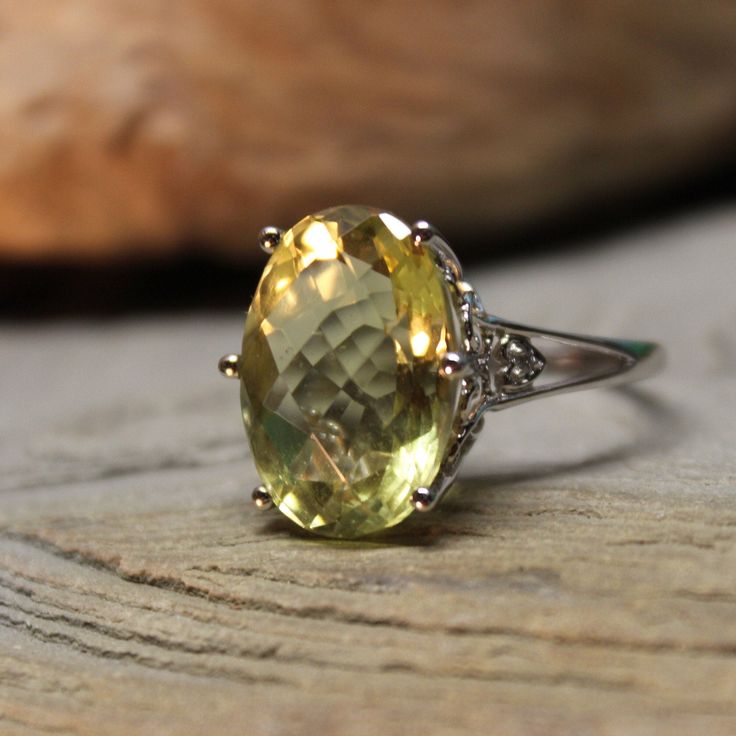 Stunning 2000 Vintage 14k Solid Gold 12.5 ctw Large Topaz Ring 5.3 Grams Size 7.5 Solid Gold Topaz Ring Vintage Gold Ring Vintage Gold Topaz Ring *Last photo* There is an appraisal for the ring which was done in 2007 & valued then at $499  Beautiful single large lemon topaz stone 12.5ctw & 2 diamonds set in 14k solid white gold.  2000 The large lemon topaz stone is 12.48ctw & measures 1/2" x 3/4" and is beautiful. The stone sits 1/2" above the finger There are 2 diamonds, one each side & are app Elegant Oval Yellow Topaz Ring, Elegant Green Oval Topaz Ring, Elegant Yellow Oval Topaz Ring, Elegant Yellow Topaz Ring With Gemstone Accents, Formal Yellow Topaz Ring With Diamond Accents, Elegant Yellow Oval Birthstone Ring, Exquisite Gemstone Topaz Ring For Anniversary, Exquisite Topaz Gemstone Ring For Anniversary, Yellow Topaz Ring With Gemstone Accents