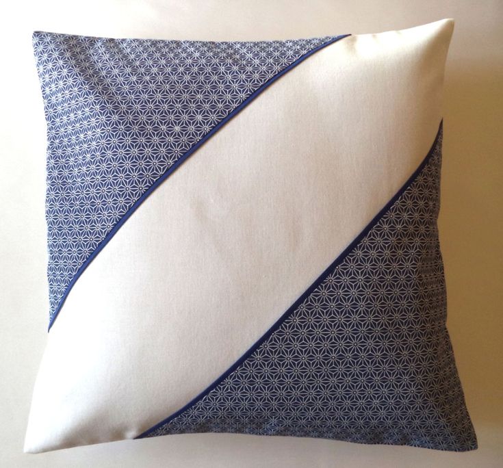 a blue and white pillow with an abstract design