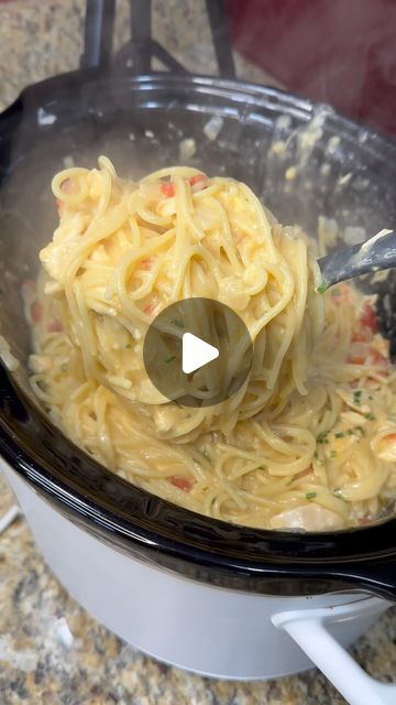 pasta being cooked in an electric pressure cooker with a ladle full of it