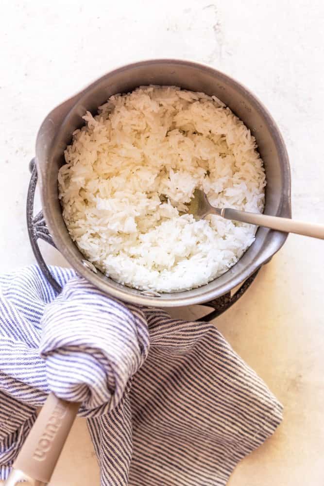 a bowl filled with rice on top of a blue and white towel