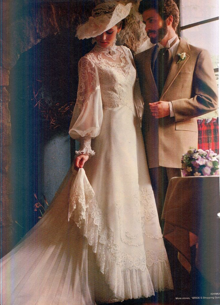 a man and woman standing next to each other wearing wedding dresses with lace on them