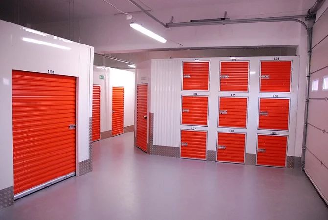 an empty storage room with orange and white doors