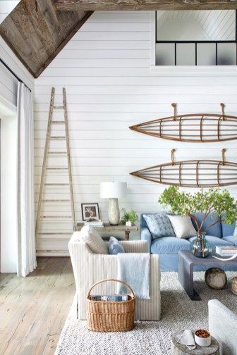 a living room filled with furniture and a wooden ladder hanging from the ceiling above it