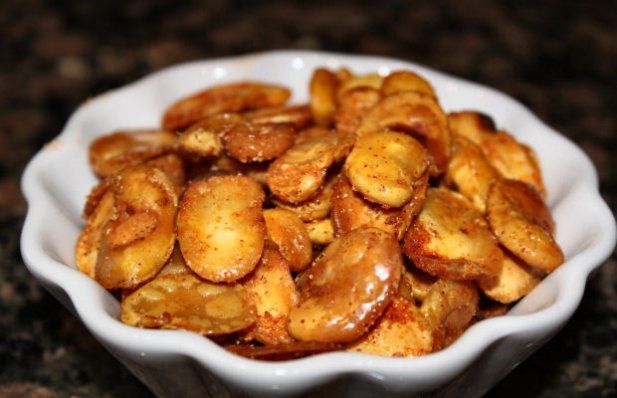 a white bowl filled with fried bananas on top of a counter