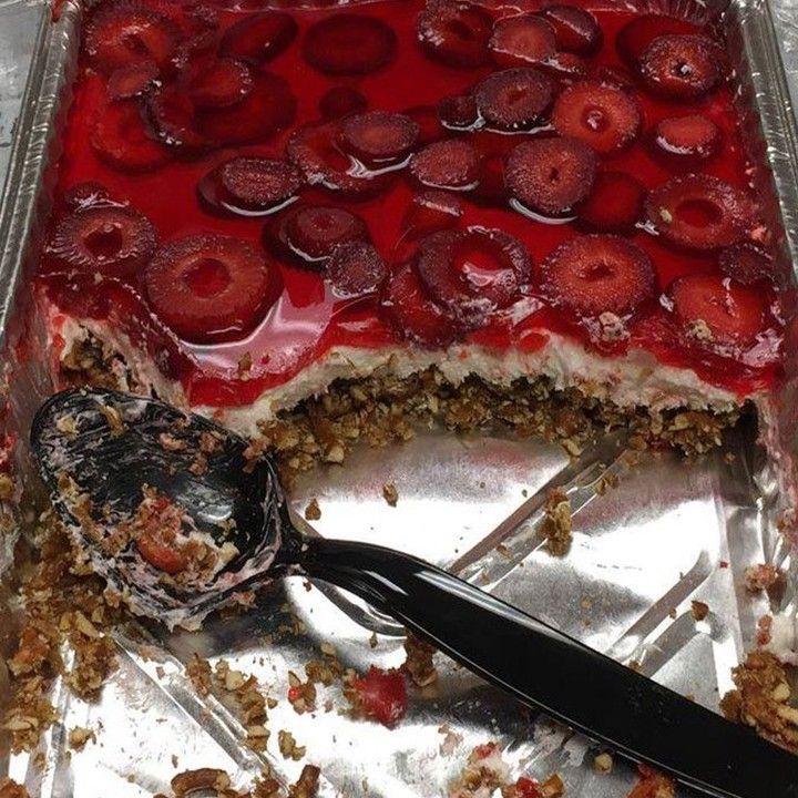 there is a cake with strawberries on it and a fork in the middle of it