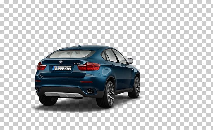 the rear end of a blue bmw x4 parked in front of a white background