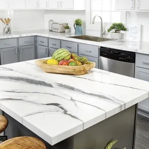 a kitchen with marble counter tops and stainless steel appliances in the back drop off area