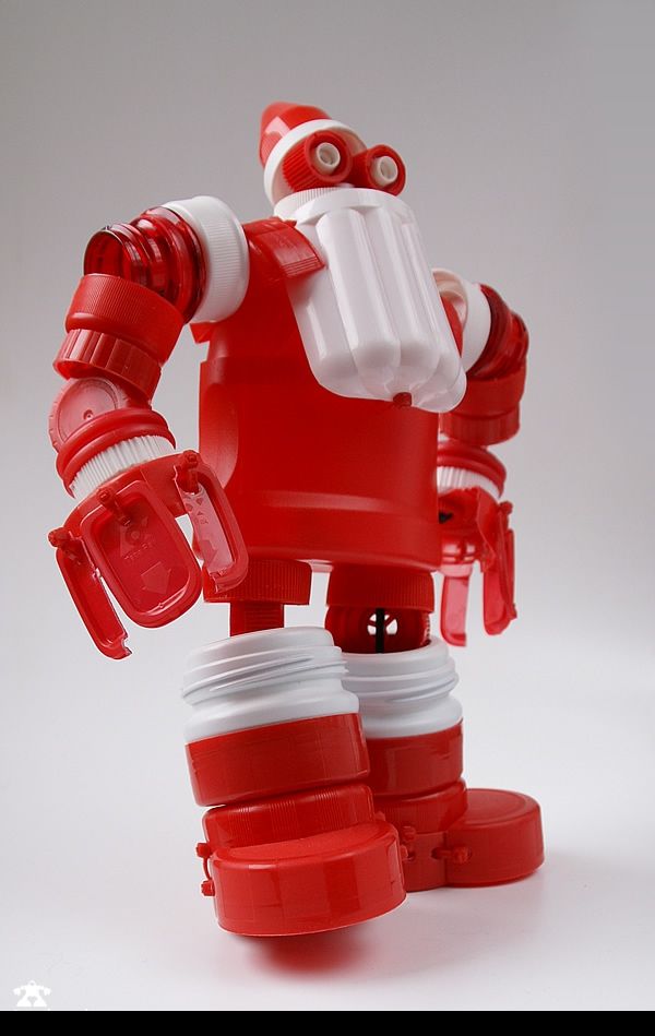 a red and white toy robot holding two cups