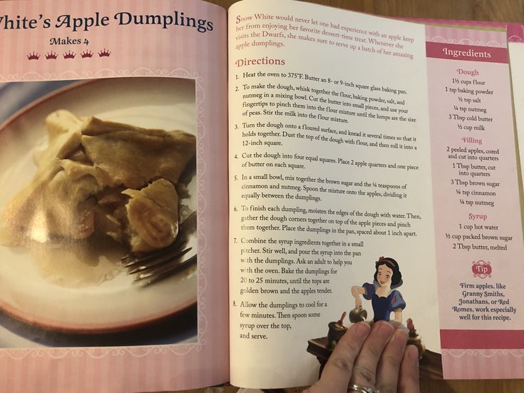 a person is holding an open book with food on it and the pages have pictures of apple dumplings