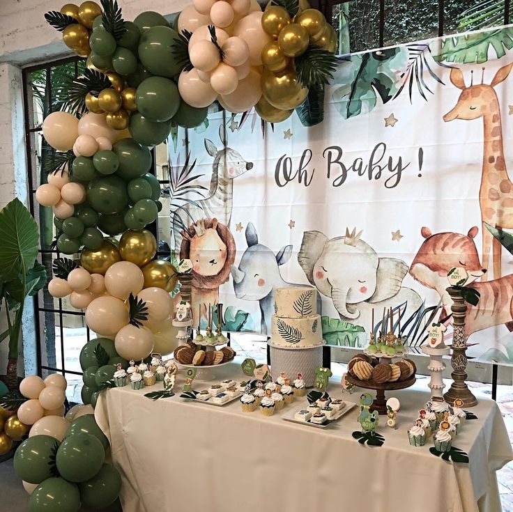 a table topped with lots of balloons and desserts