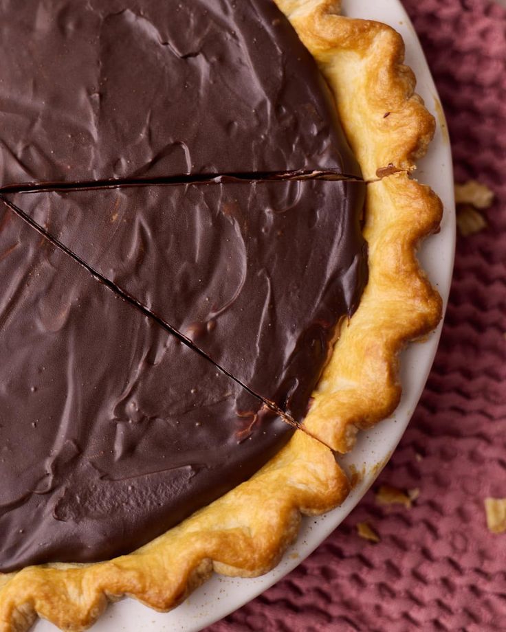 a chocolate pie with one slice missing from it