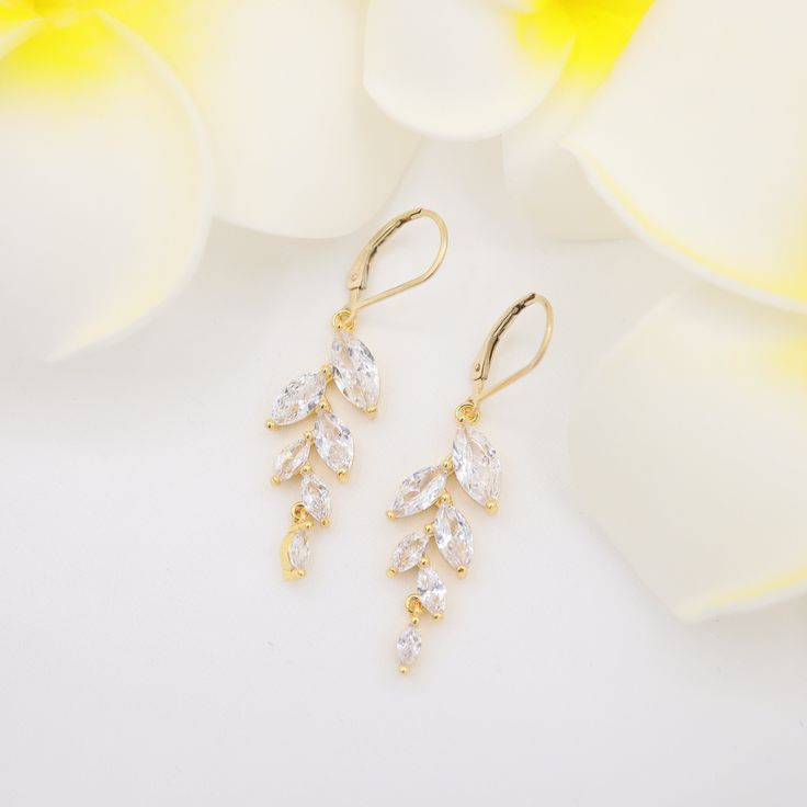 Dainty olive leaf vine dangle earrings. Designed and handcrafted in our Burlington Studio. ------------------------------------------------------------- PRODUCTS DETAILS Length: 45mm Vine drops: 35X12mm Lever backs: 14K gold filled Vine drops: 14K gold plated cubic zirconia ------------------------------------------------------------- SAME COLLECTION Necklace -1 https://www.etsy.com/ca/listing/787996503/olive-leaf-vine-pendant-necklace-diamond?ref=shop_home_active_96&frs=1 Necklace -2 https://ww Elegant Marquise Gold Bridal Earrings, Elegant Gold Marquise Bridal Earrings, Dainty Marquise Wedding Earrings, Yellow Gold Crystal Earrings For Wedding, Gold Bridal Earrings With Prong Setting For Wedding, Vine Earrings, Long Tassel Earrings, Wedding Party Jewelry, Wedding Bridal Jewellery