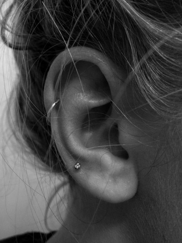 a woman's ear is shown in black and white