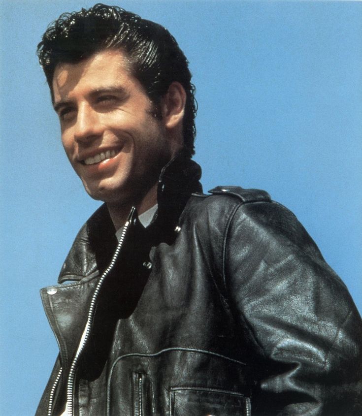 a man wearing a black leather jacket smiling