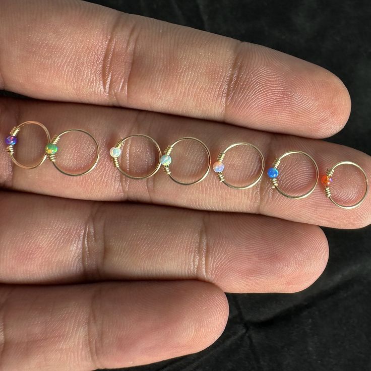 Discover elegance and simplicity with my 9K and 14K Gold single opal seamless nose hoop ring. Handcrafted to perfection, this exquisite piece features a seamless design for comfort and a secure fit. Crafted from the finest 9K and 14K yellow gold, this nose hoop ring is not only beautiful but also durable, ensuring it will last a lifetime. The focal point is a stunning opal stone, available in multiple captivating colors, each reflecting its unique play of light. Indulge in timeless beauty and cr Opal Stud Nose Ring, Opal Nose Ring, Nose Hoop, Opal Color, Nose Ring Stud, Gold Hoop, Body Jewellery, Hoop Ring, Exquisite Jewelry