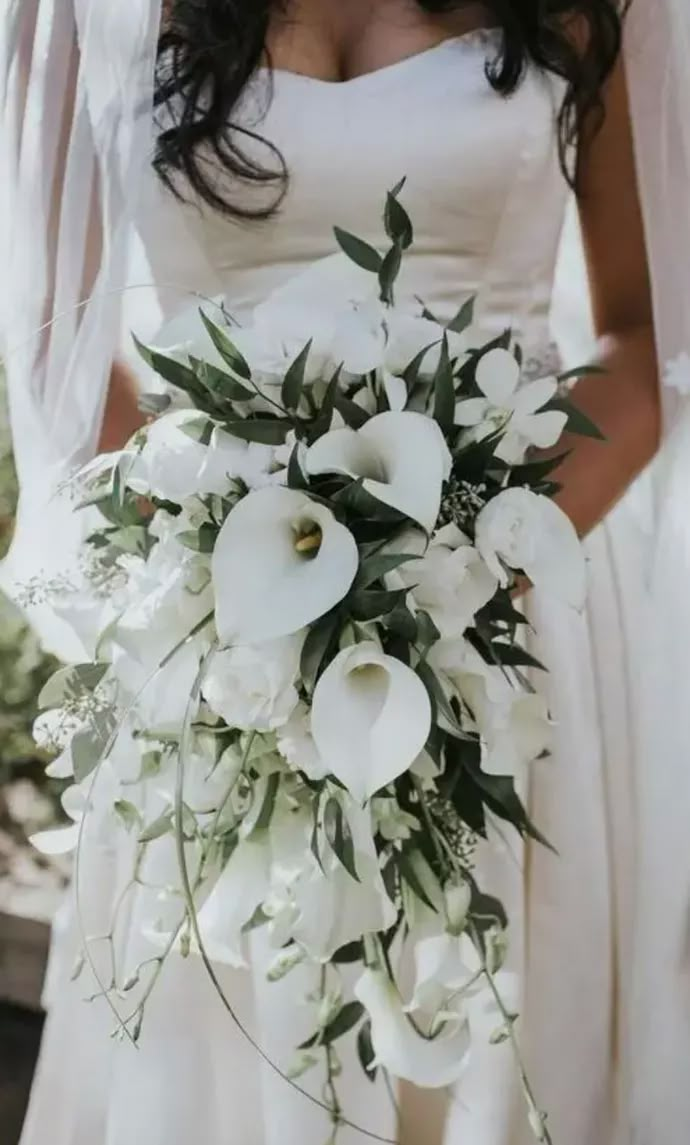 a woman in a wedding dress holding a bouquet