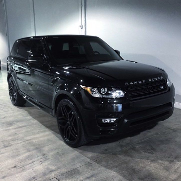 a black range rover parked in a garage