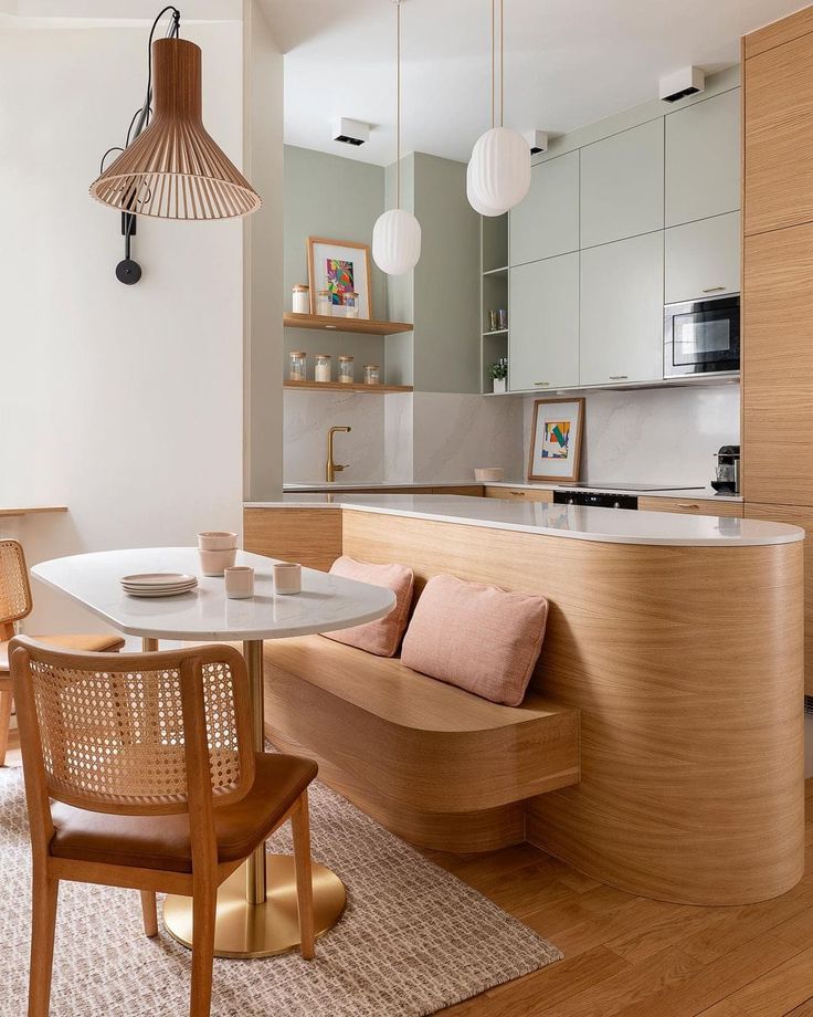 a kitchen and dining area with wooden furniture