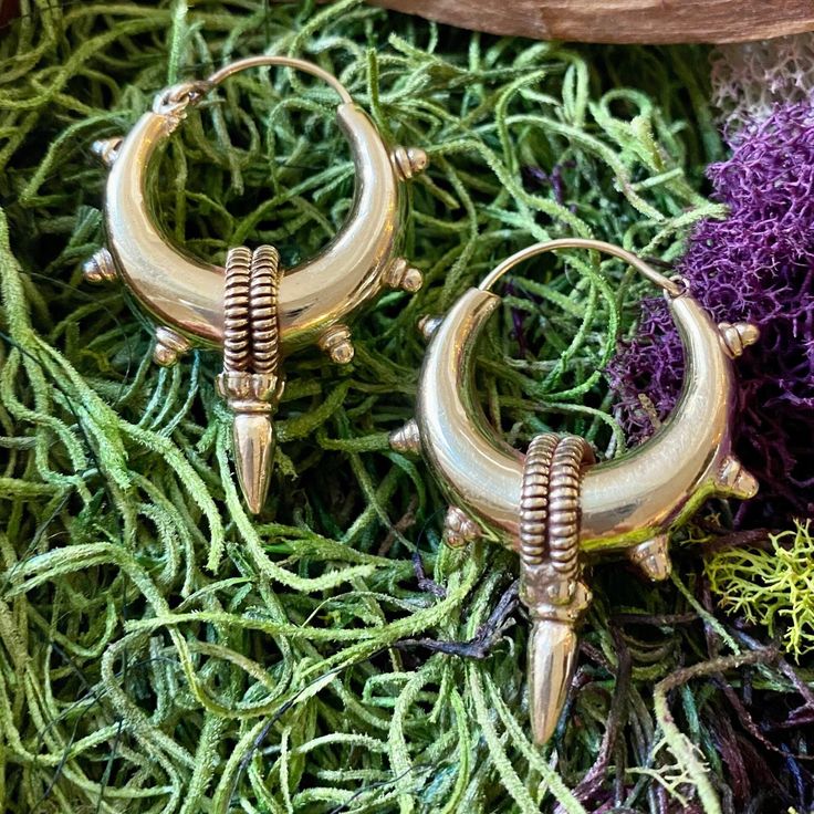 Elevate your style with our Handcrafted Statement Tribal Brass Hoop Earrings, a striking blend of bold design and cultural influence. Meticulously handcrafted, these earrings capture the essence of tribal aesthetics, making them a powerful accessory for those who appreciate unique, statement pieces. Material: High quality brass. Width- 1 /4 inches   Length - 2 inches. 🔶🌟 **Key Features - **Artisanal Craftsmanship Each pair is expertly crafted, ensuring intricate detailing and a one-of-a-kind design. - **Statement Tribal Design The bold brass hoops draw inspiration from tribal motifs, making these earrings a standout accessory. - **Versatile Statement Piece Whether for everyday wear or special occasions, these earrings make a powerful style statement. - **Secure Closure The well-designed Bohemian Brass Jewelry For Rituals, Bohemian Bronze Single Earring, Bohemian Jewelry For Ceremonial Festival, Bohemian Festival Jewelry For Ceremonial Occasions, Traditional Bronze Pierced Earrings, Bronze Bohemian Earrings With Ear Wire, Bohemian Bronze Earrings With Ear Wire, Traditional Single Brass Earring, Bohemian Metal Jewelry For Ceremonial Occasions