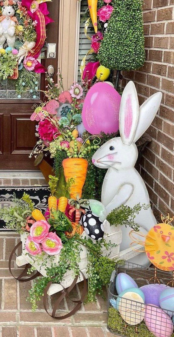 a front porch decorated for easter with flowers and bunnies, bunny ears, and other decorations