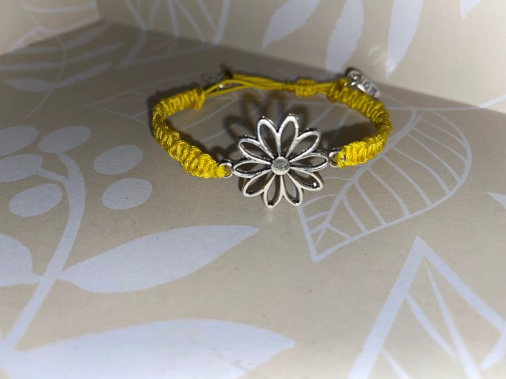 This vibrant yellow handmade macrame bracelet is a must have! It features a cute flower as its centerpiece. Perfect accessory for your super sunny spring and summer days 😎 Bohemian Bracelets With Flower Charm For Spring, Yellow Bohemian Flower Bracelets, Yellow Braided Bracelet For Gift, Yellow Flower Bracelets For The Beach, Yellow Flower Bracelets For Beach, Yellow Flower Bracelet For The Beach, Yellow Friendship Bracelets As Summer Gifts, Casual Yellow Friendship Bracelets With Sliding Knot, Spring Bohemian Braided Bracelets As Gift