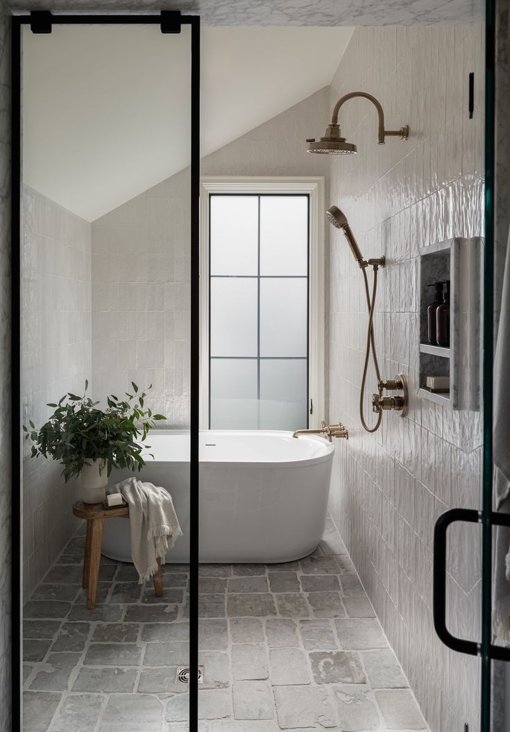 a bathroom with a bathtub, shower and sink