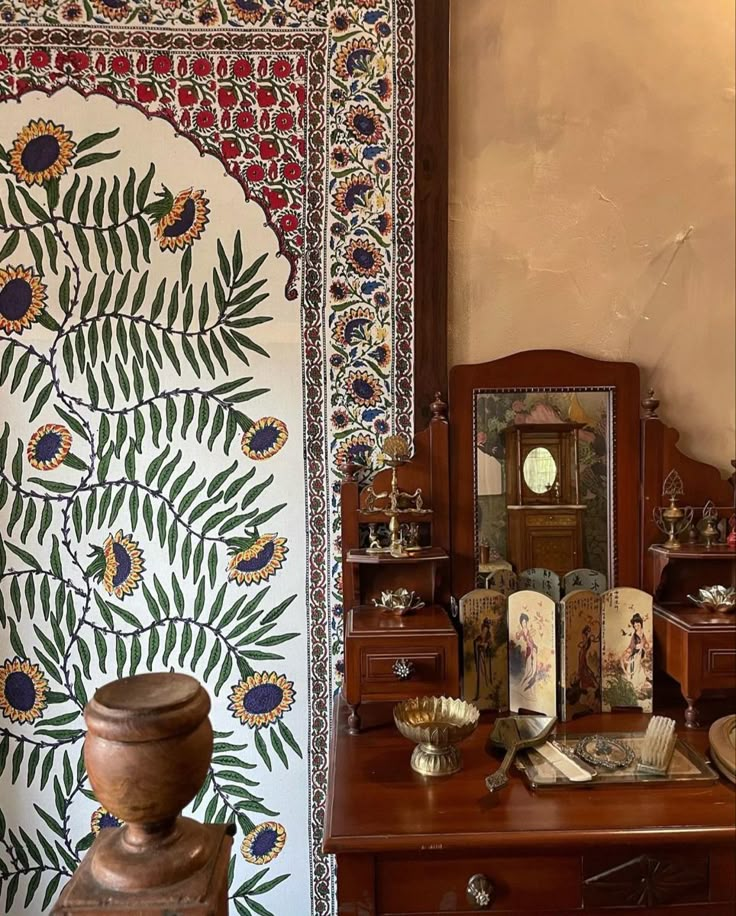 an ornately decorated room with many items on the table and in front of a mirror