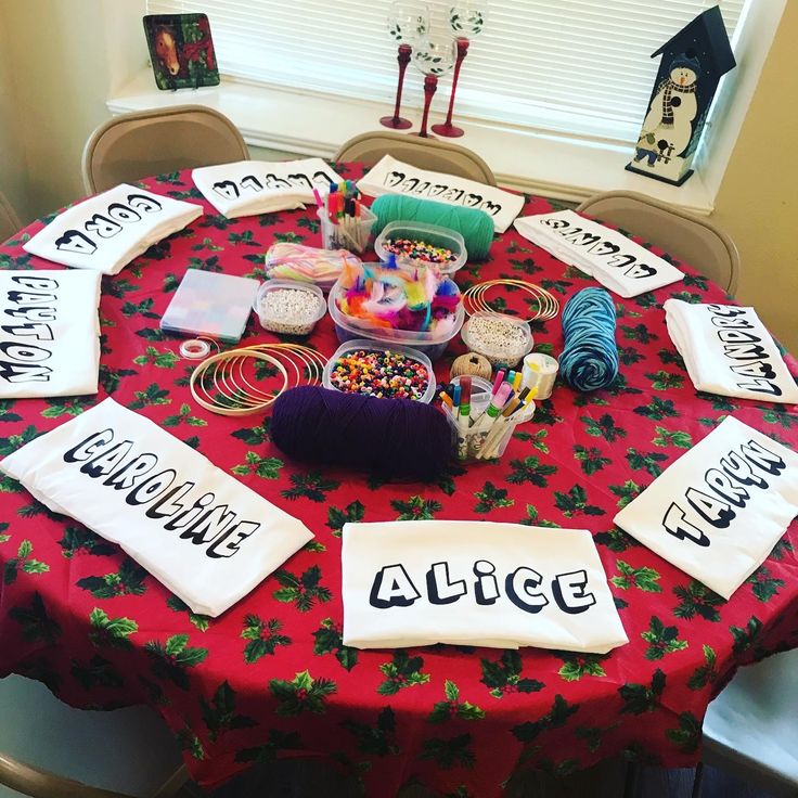 a red table topped with lots of different types of crafting supplies on top of it