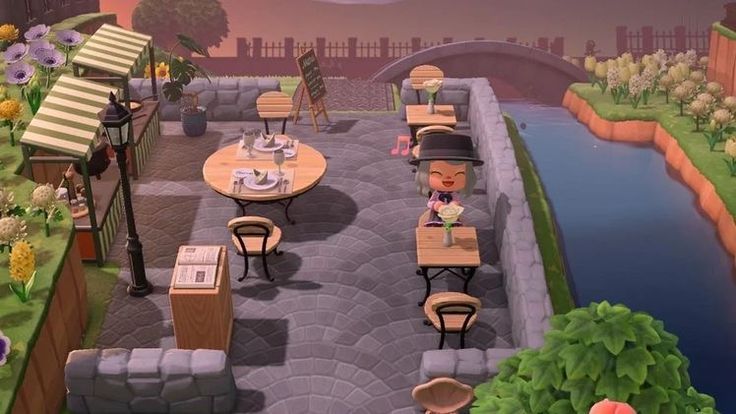 an animated image of tables and chairs in a garden with flowers on the side walk