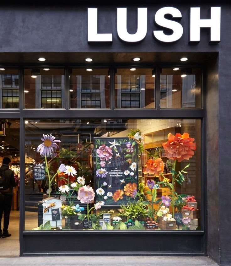 a store front with flowers in the window