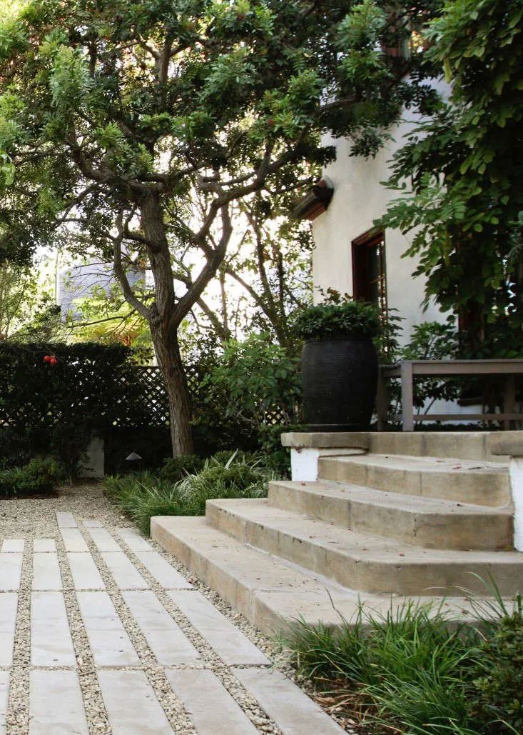 an outdoor patio with stone steps and trees