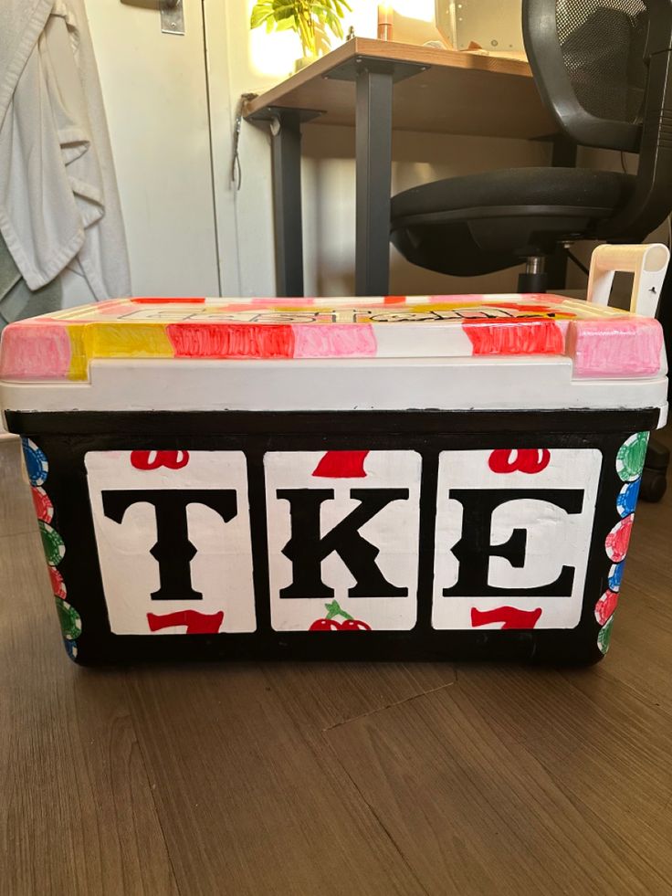 an ice chest sitting on top of a wooden floor