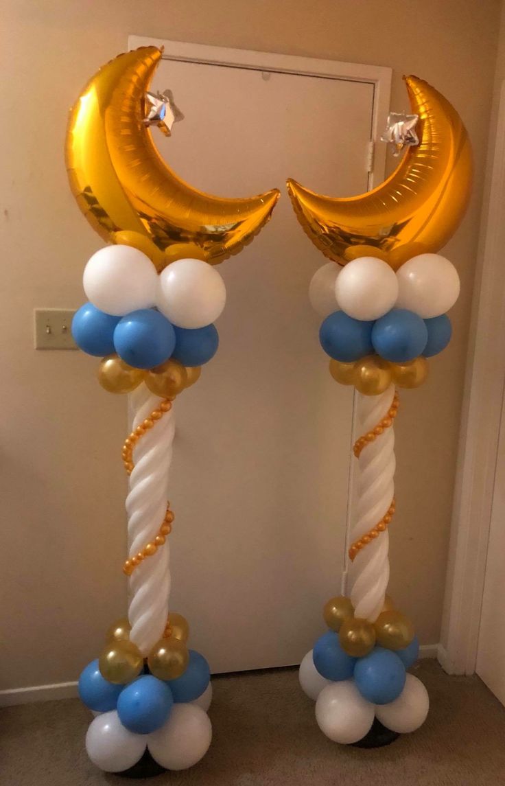 two balloons are attached to the poles in front of a door with a crescent and stars on them