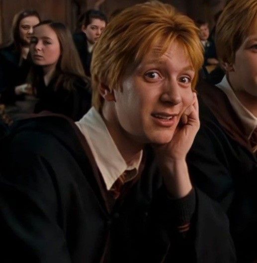 two harry potters are sitting next to each other in front of a group of people