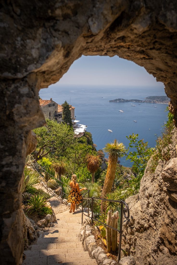 a view from inside a cave looking out at the ocean