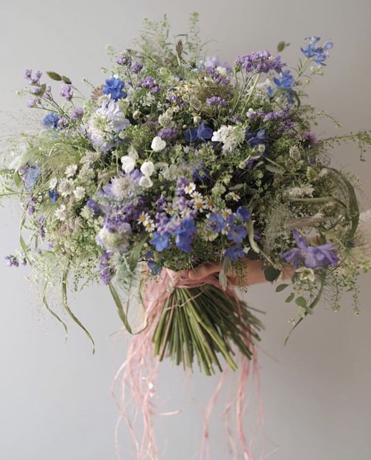 a person holding a bunch of flowers in their hands