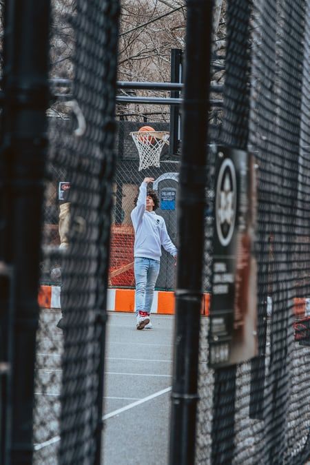 a man is throwing a basketball in the air