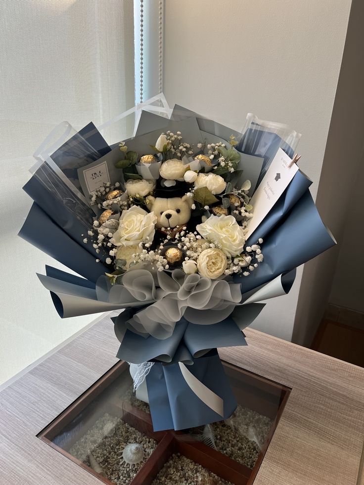 a bouquet of flowers with teddy bears and baby's breath